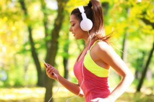 Woman with white headphones jogging