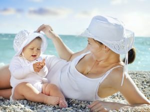 mother with her baby on the beach