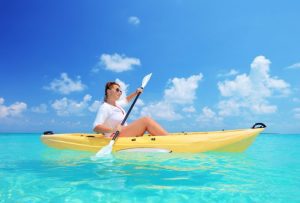 Woman Kayaking on Pretty Ocean