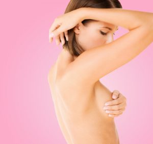 woman checking breast for signs of cancer-img-blog